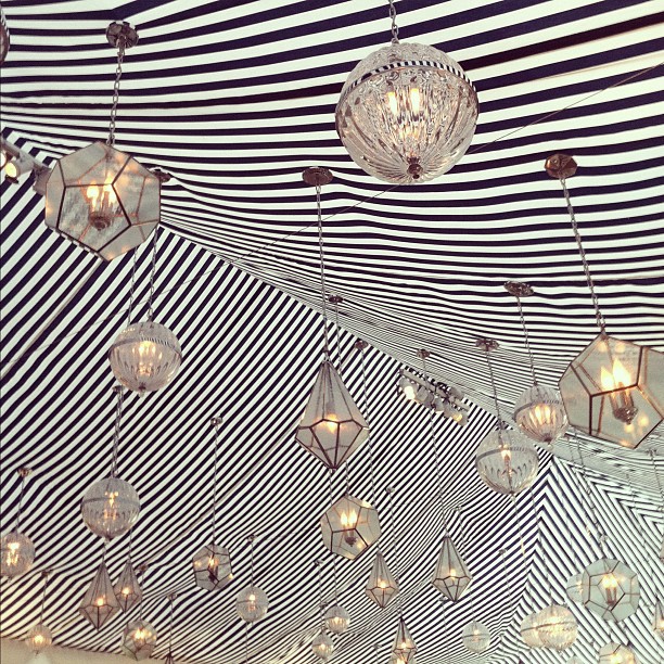 black + white striped tent + mixed chandeliers